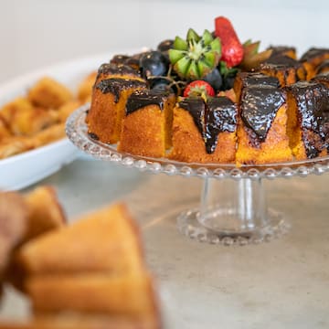 a cake with chocolate frosting and fruit on a plate