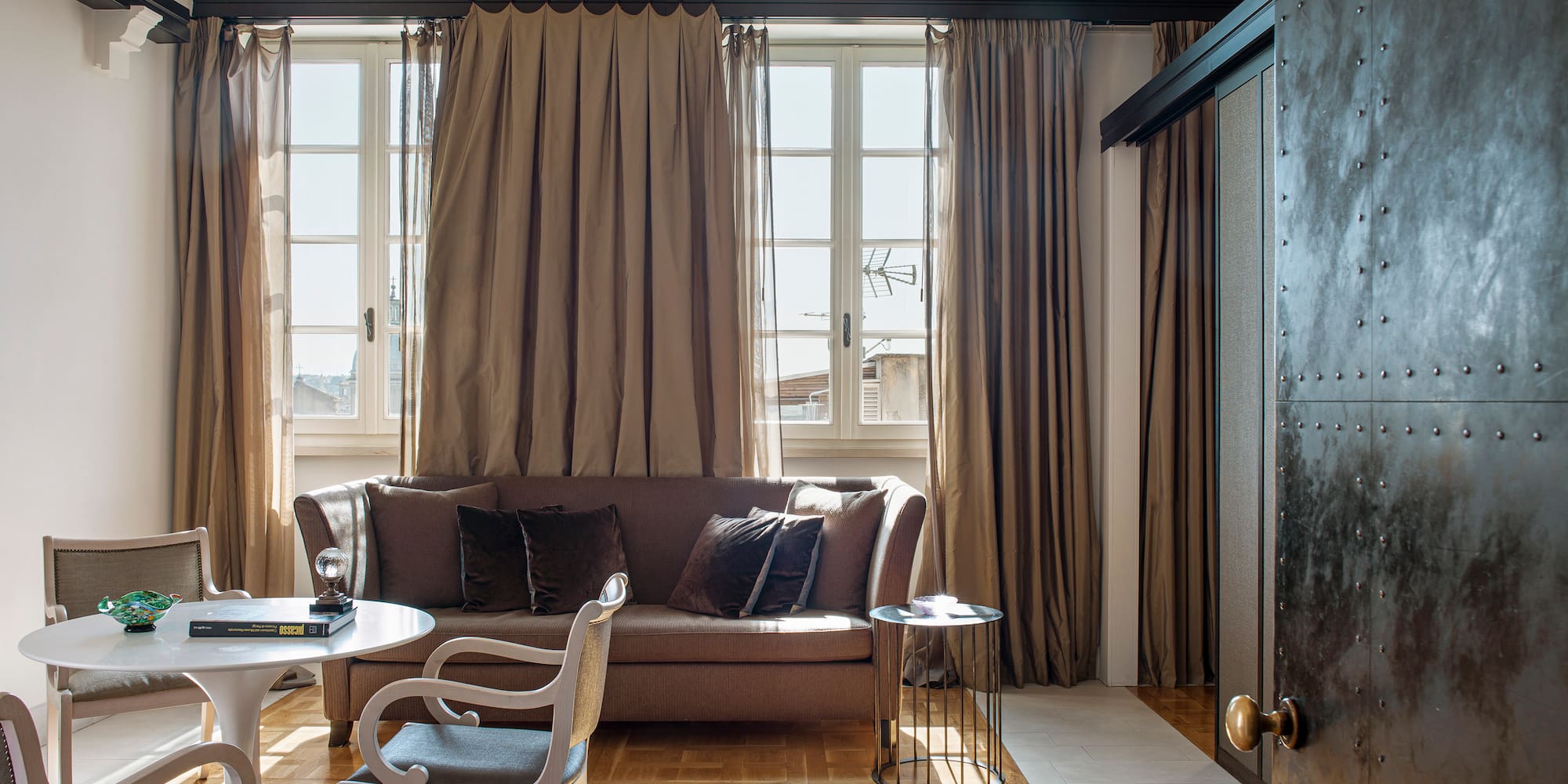 a living room with a couch and chairs