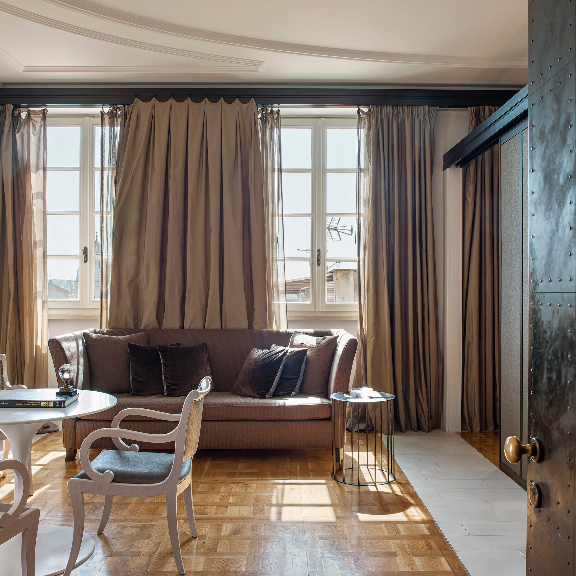 a living room with a couch and chairs