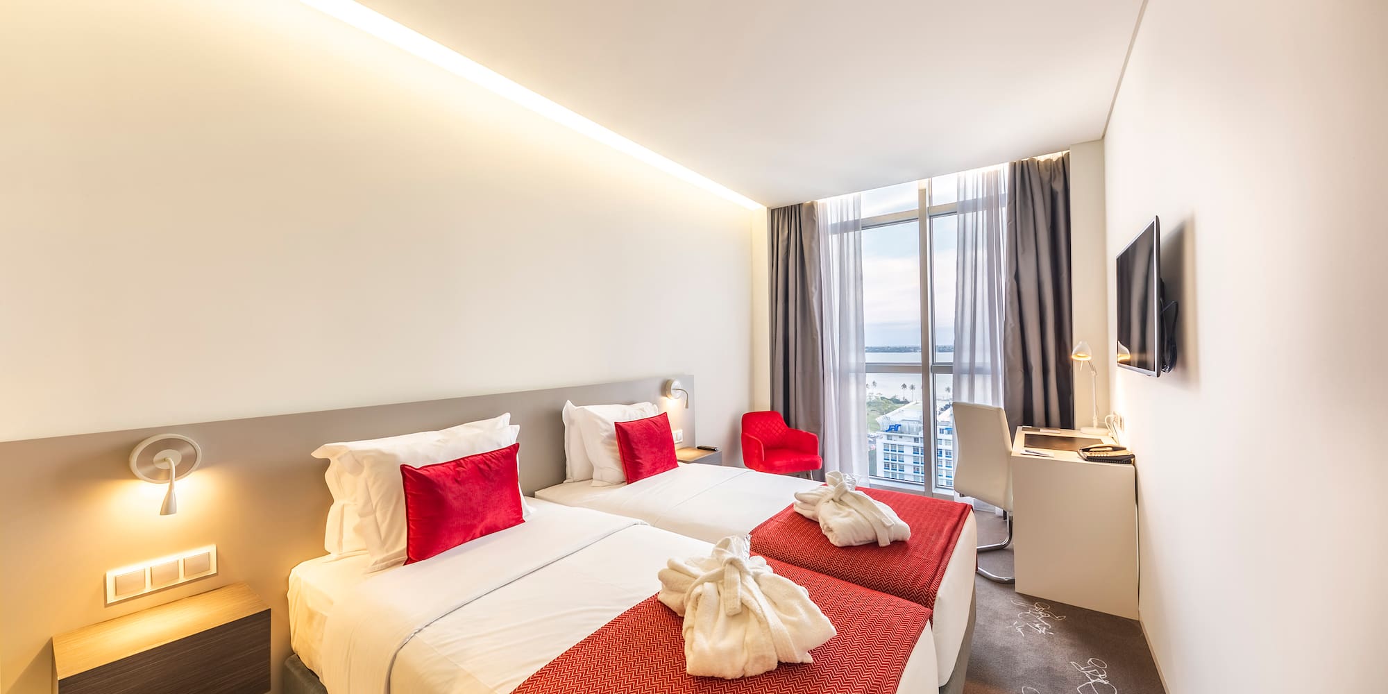 a hotel room with two beds and a tv