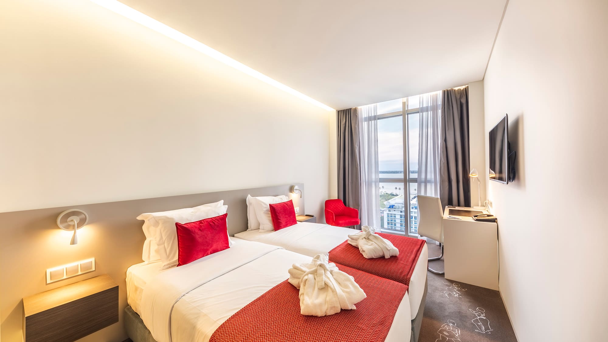 a hotel room with two beds and a tv