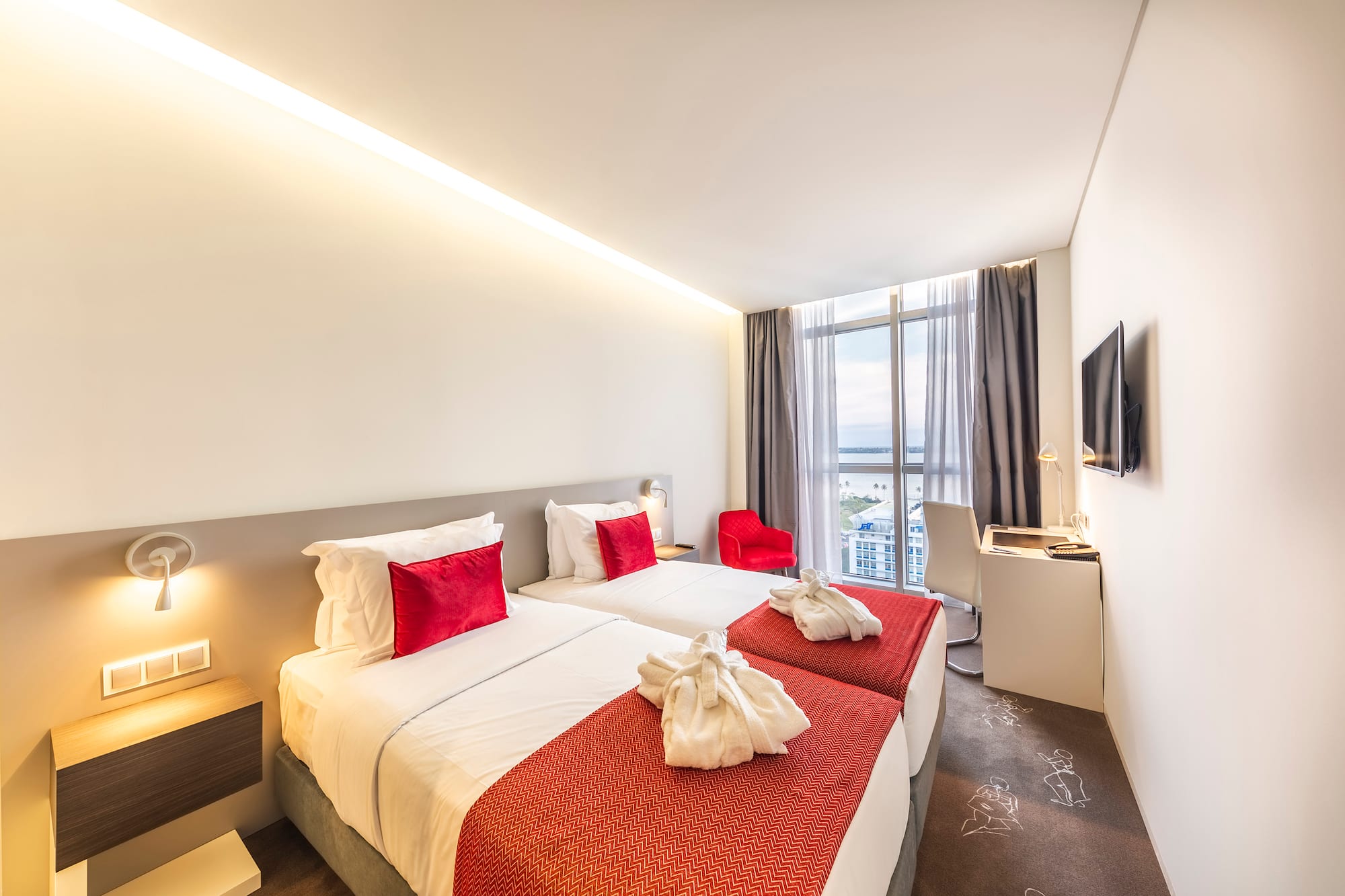 a hotel room with two beds and a tv