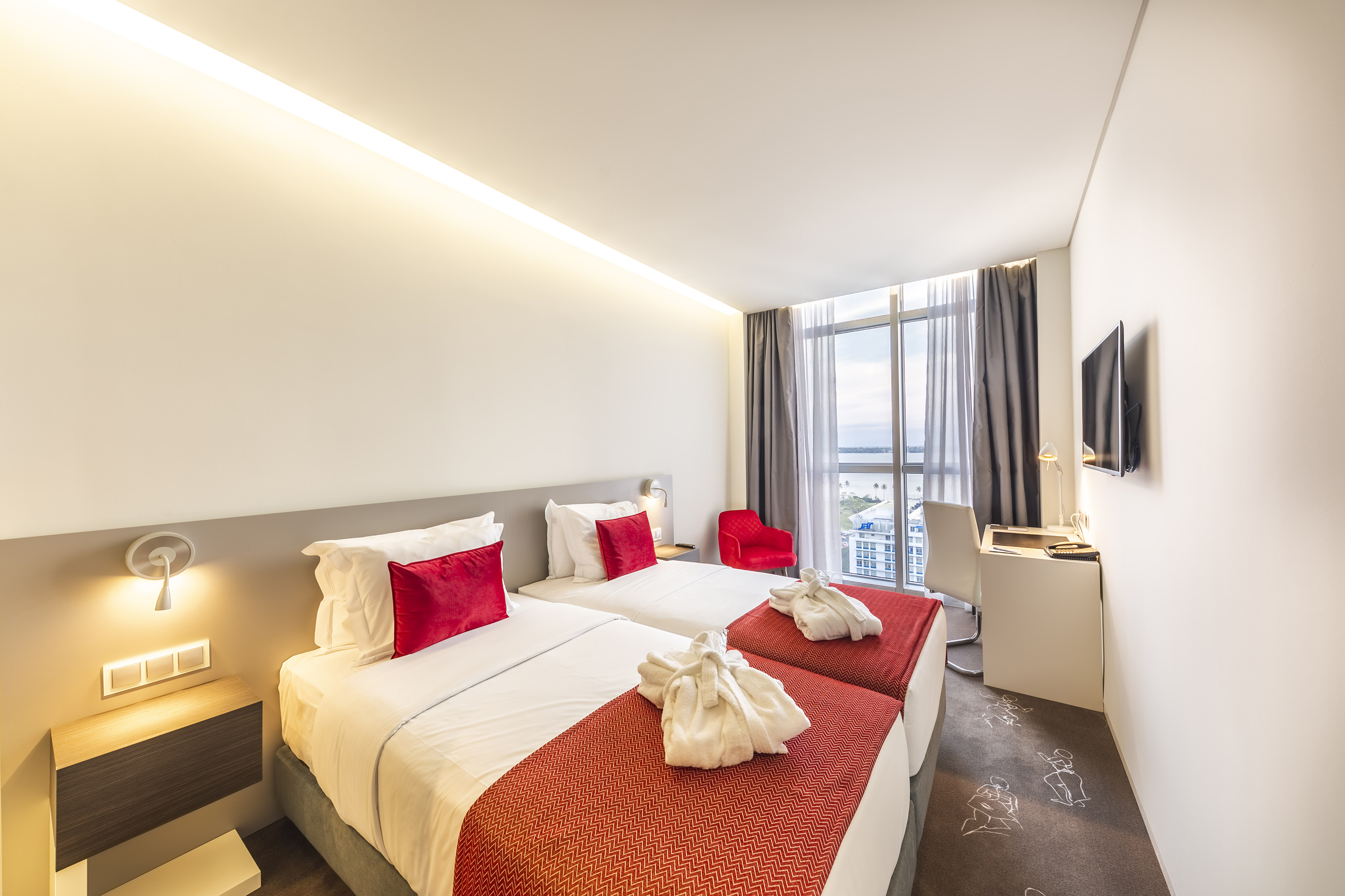 a hotel room with two beds and a tv