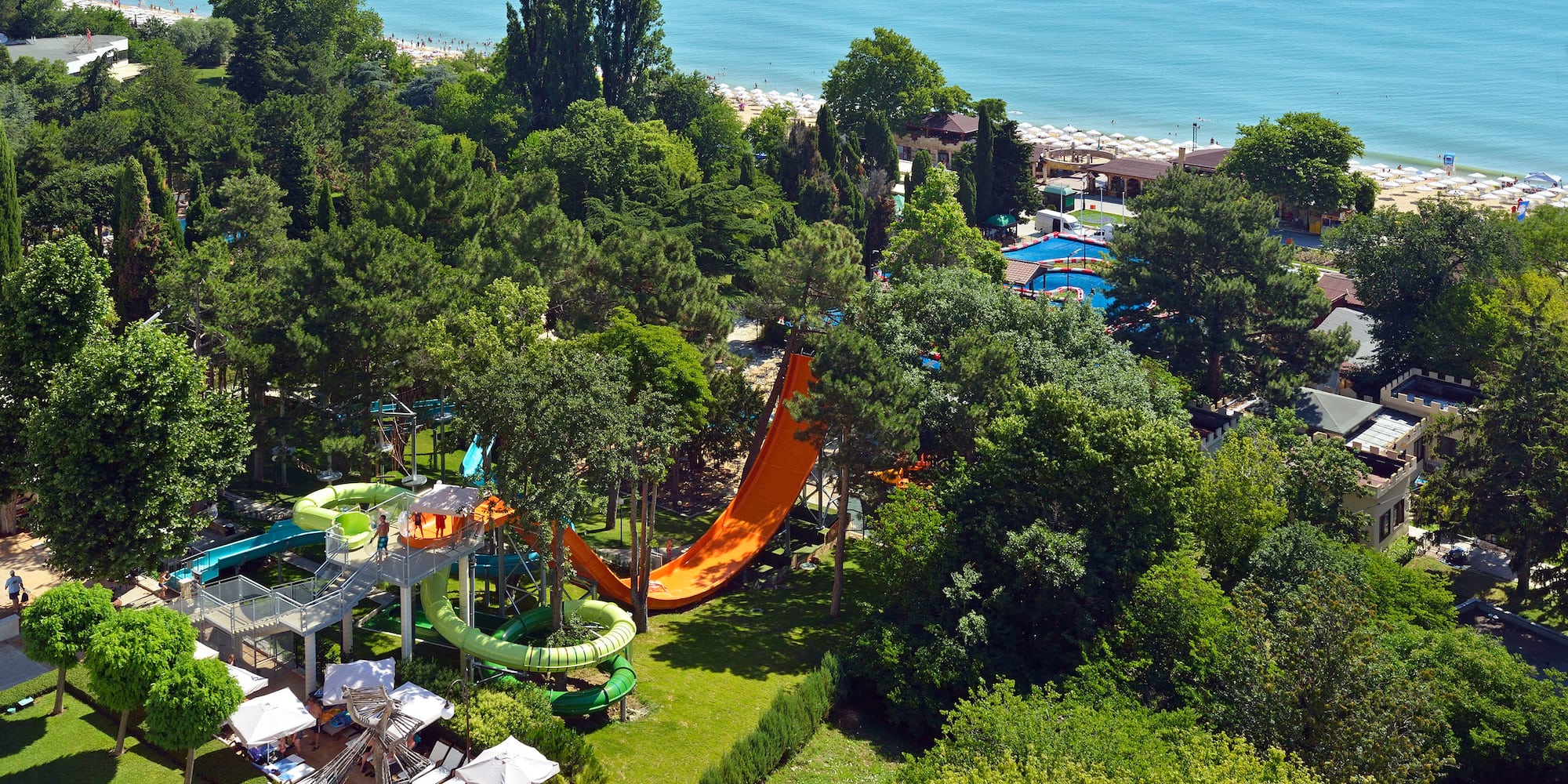a water park with a slide and trees