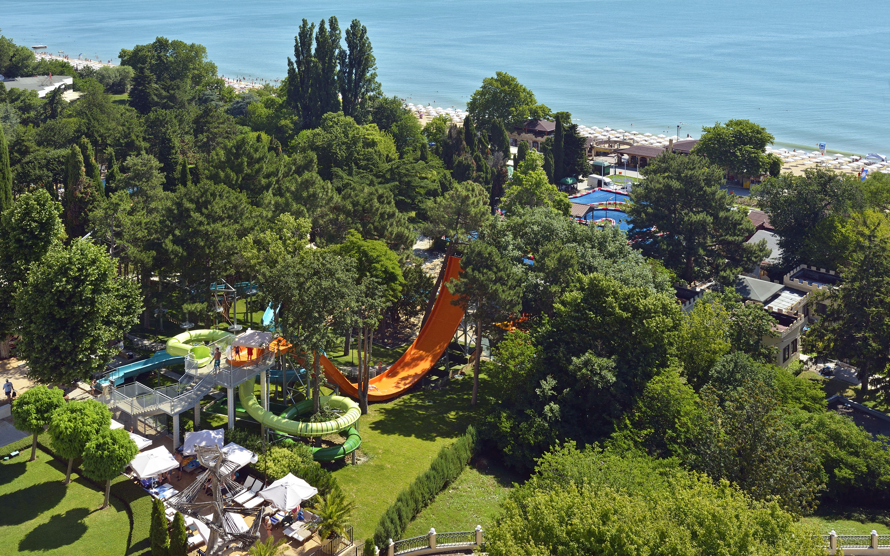 a water park with a slide and trees