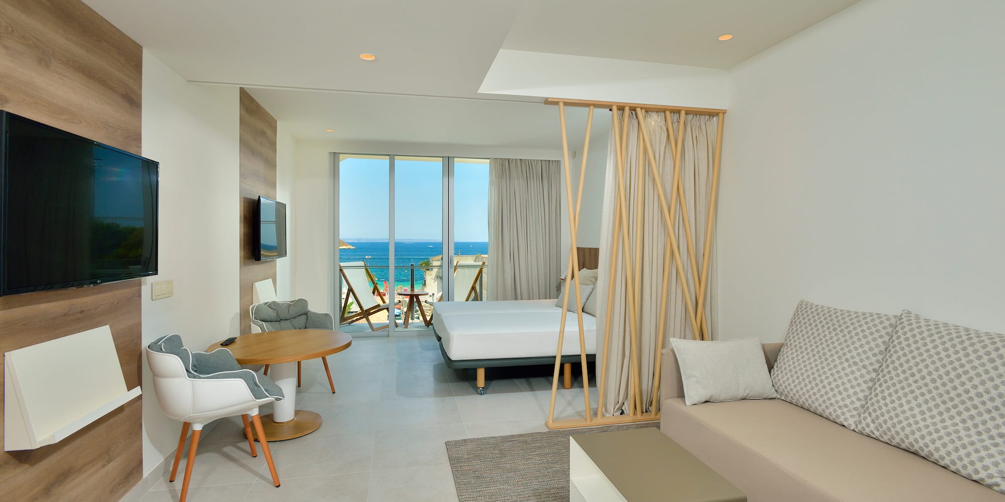 a room with a bed and a television