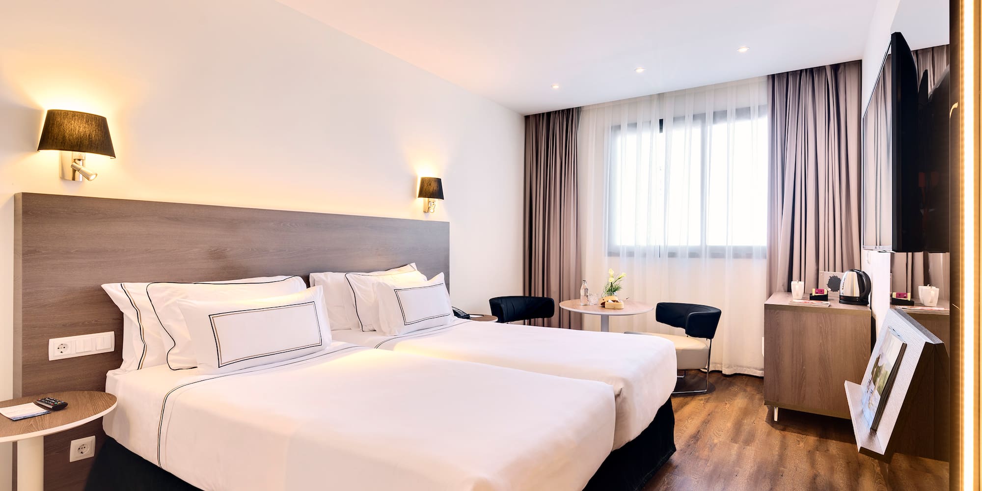 a room with two beds and a table