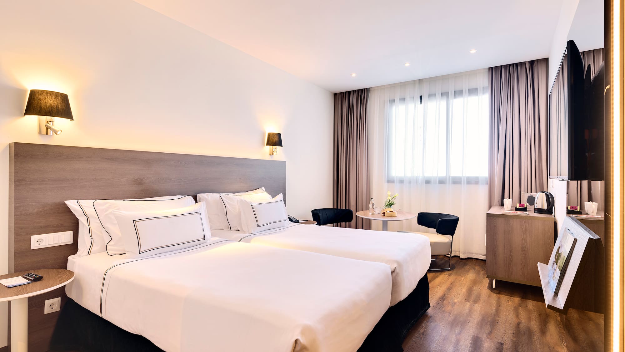 a room with two beds and a table