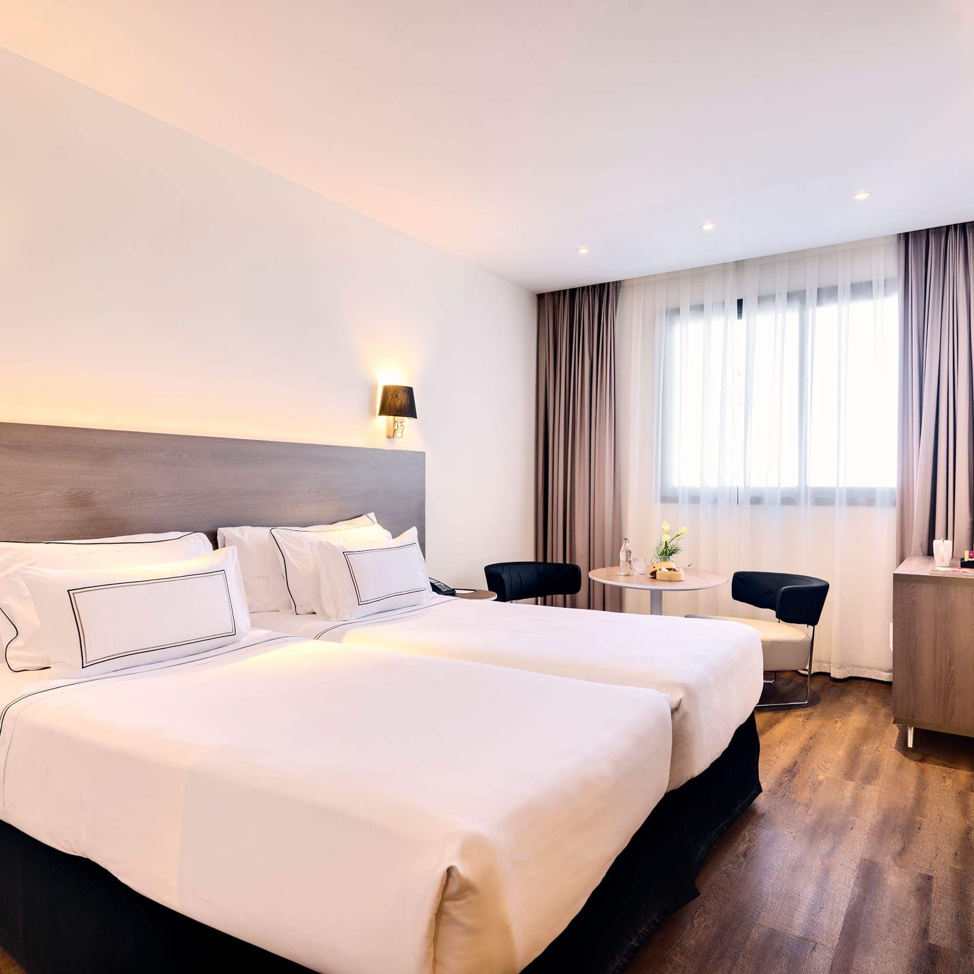 a room with two beds and a table