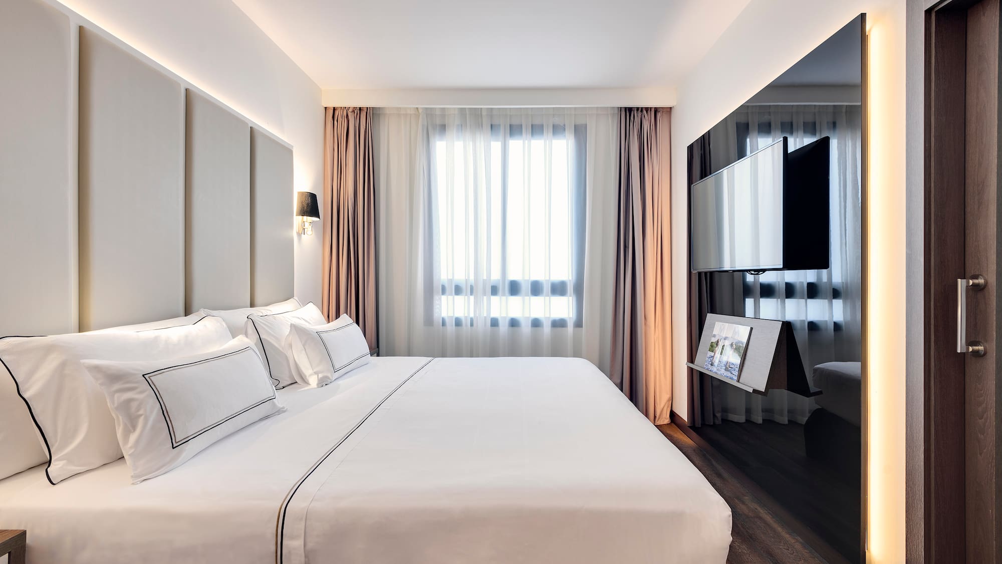 a bedroom with a large bed and a mirror