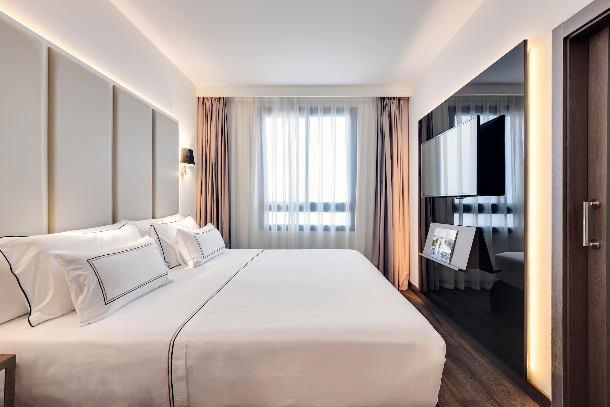 a bedroom with a large bed and a mirror