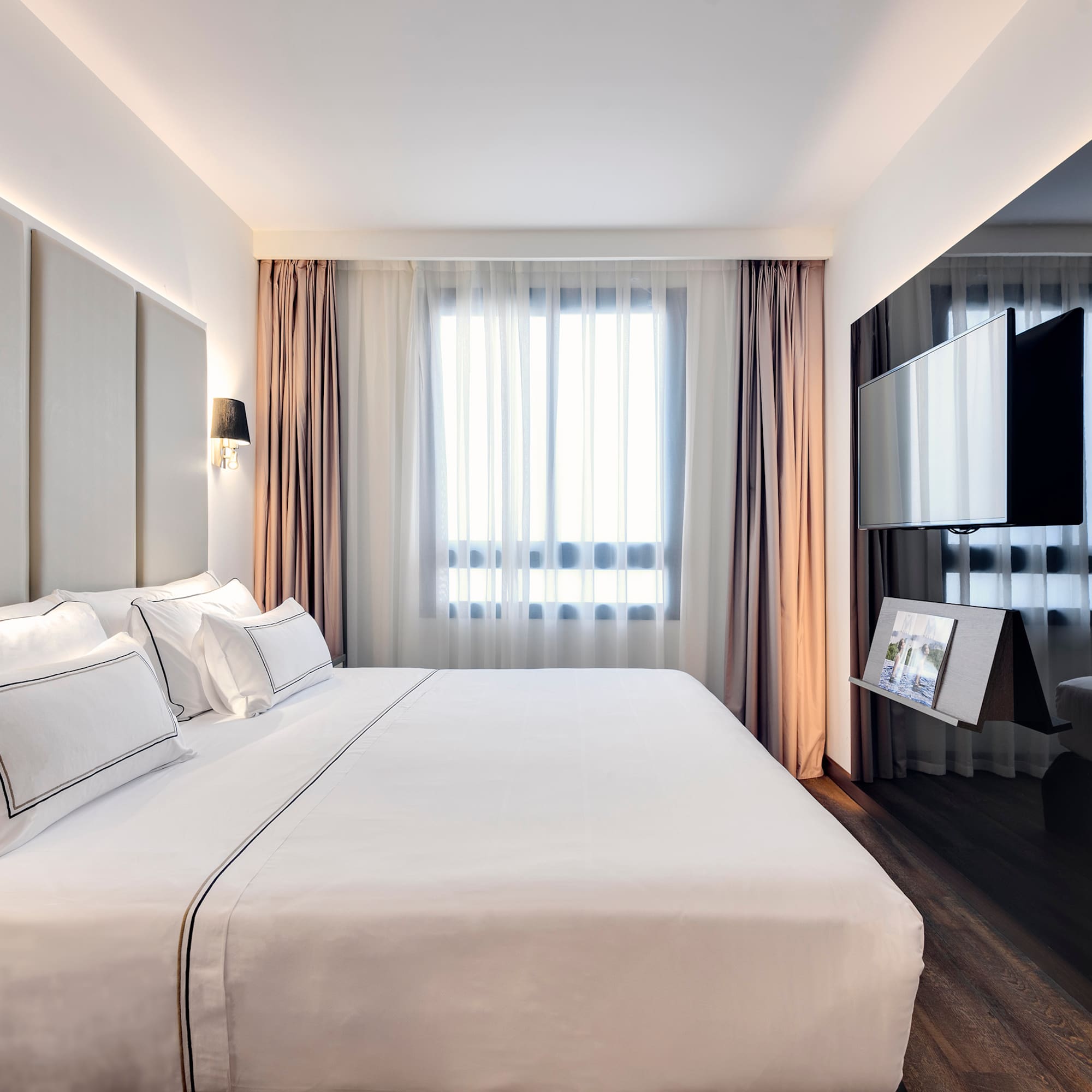 a bedroom with a large bed and a mirror