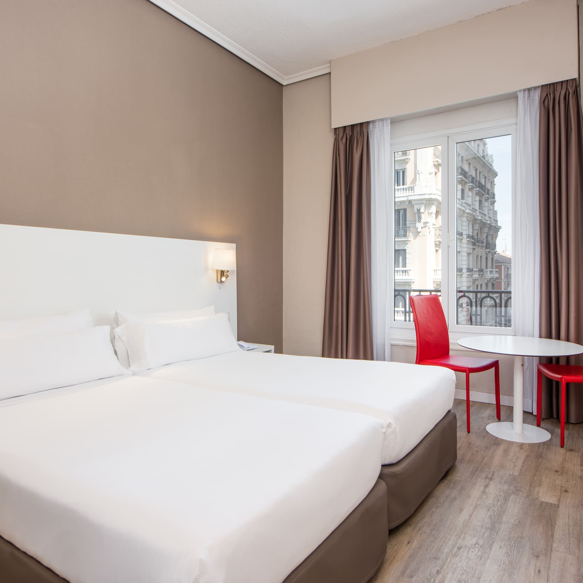 a room with two beds and a table