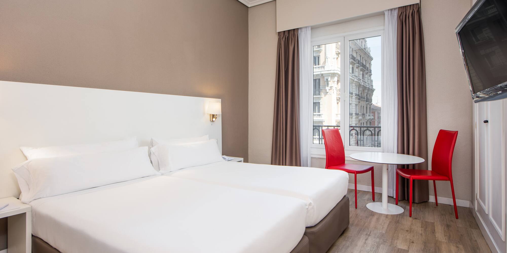 a room with two beds and a table