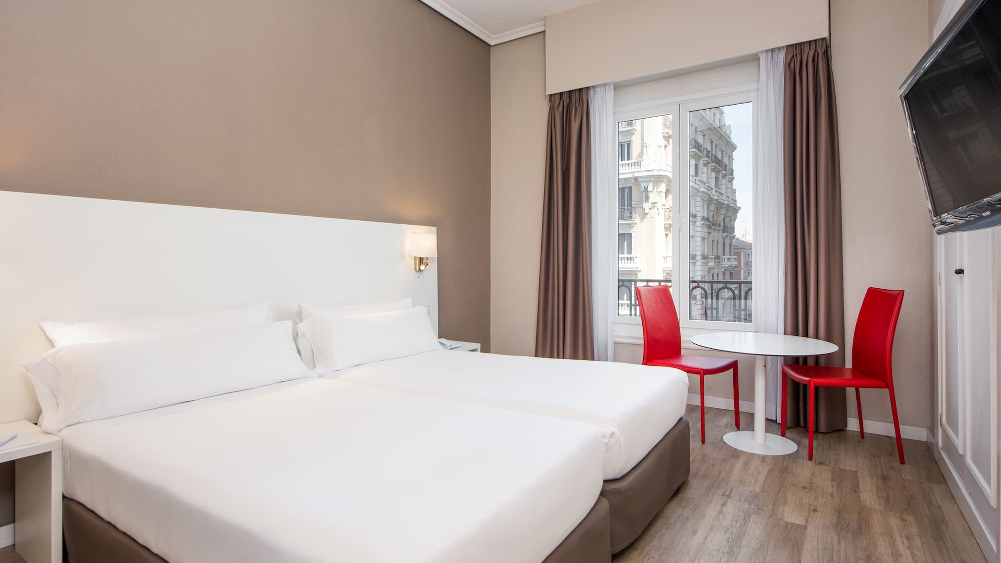 a room with two beds and a table