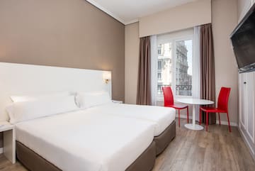 a room with two beds and a table