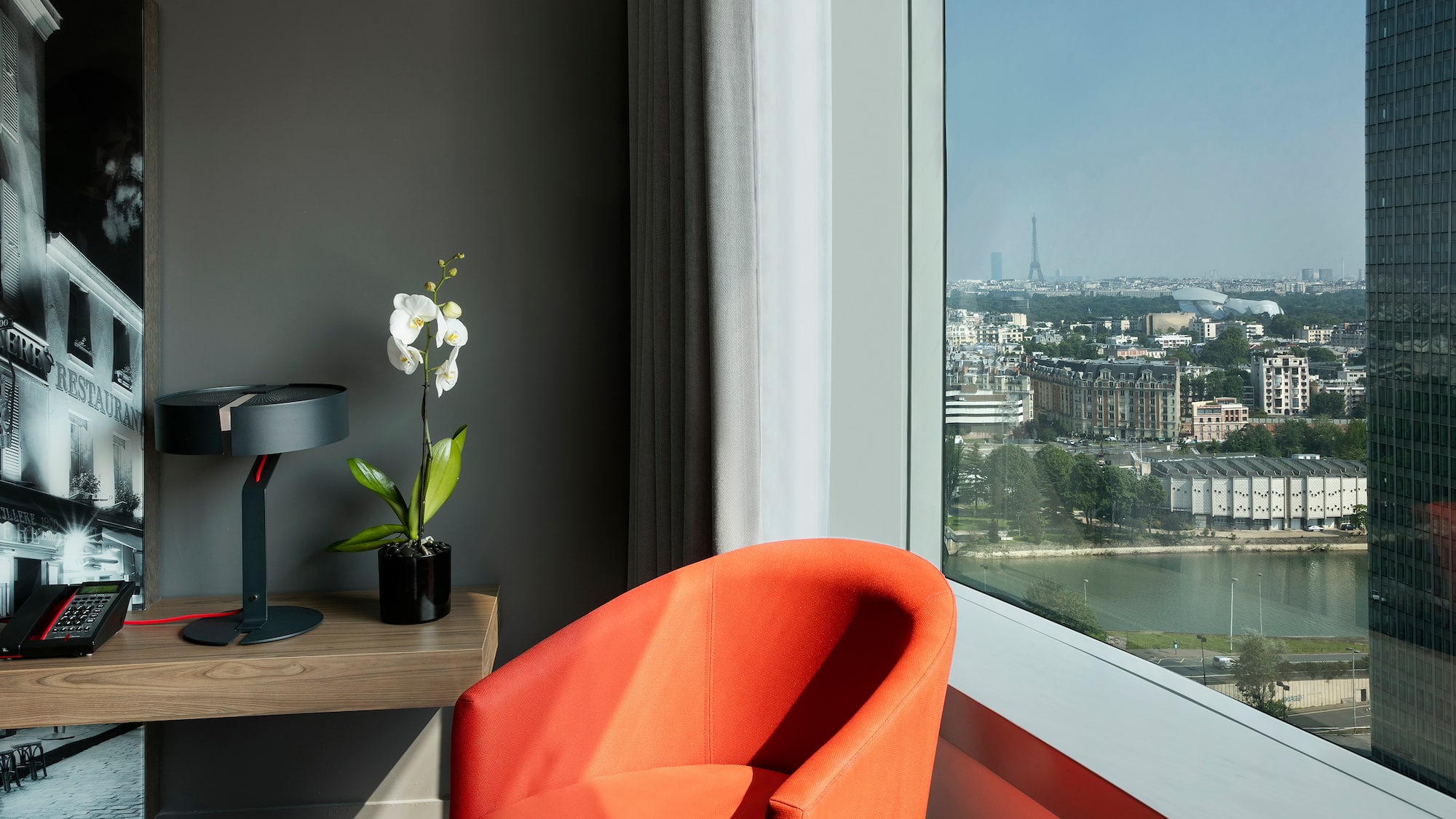 a room with a large window and a chair