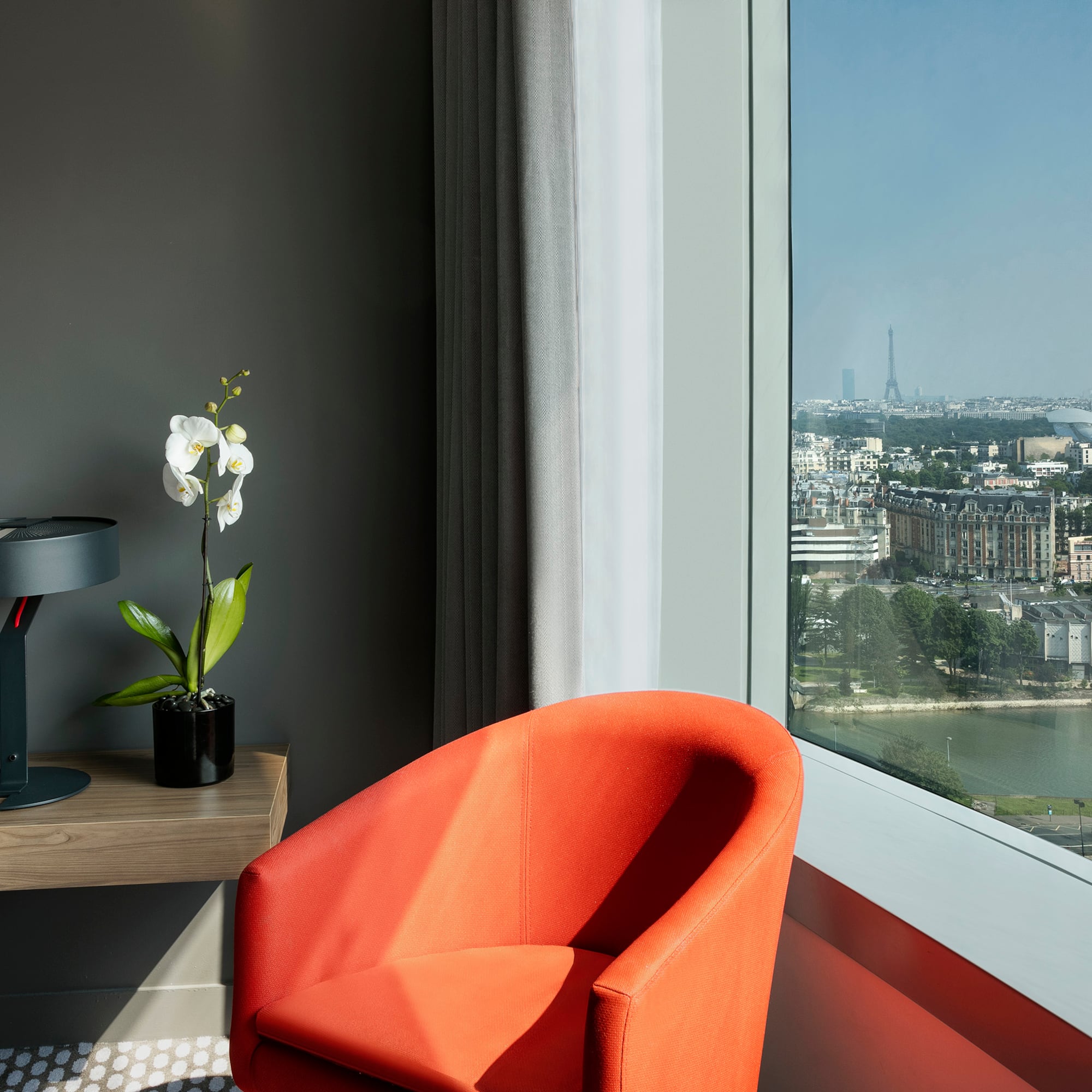 a room with a large window and a chair
