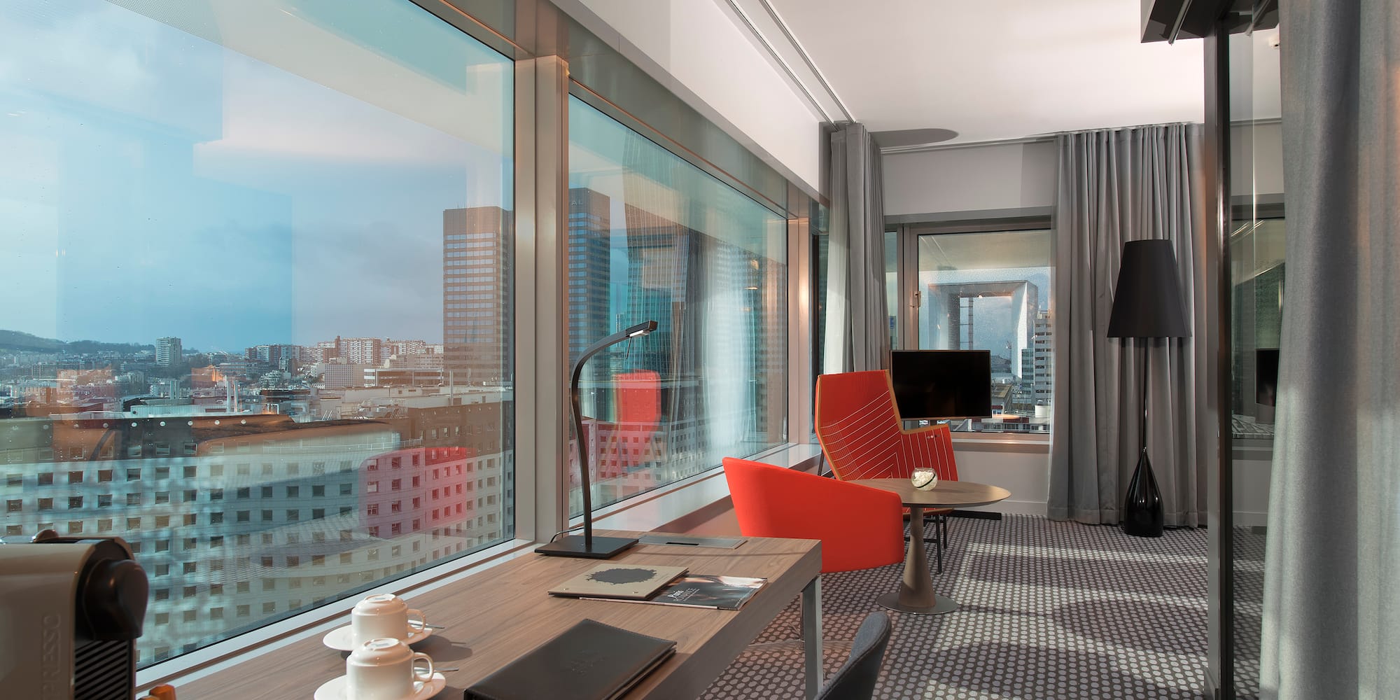 a room with a table and chairs and a window