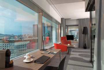 a room with a table and chairs and a window