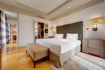 a bed with a foot board and a lamp