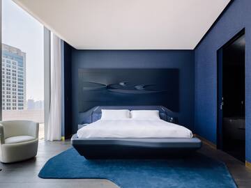 a bedroom with a bed and a blue wall