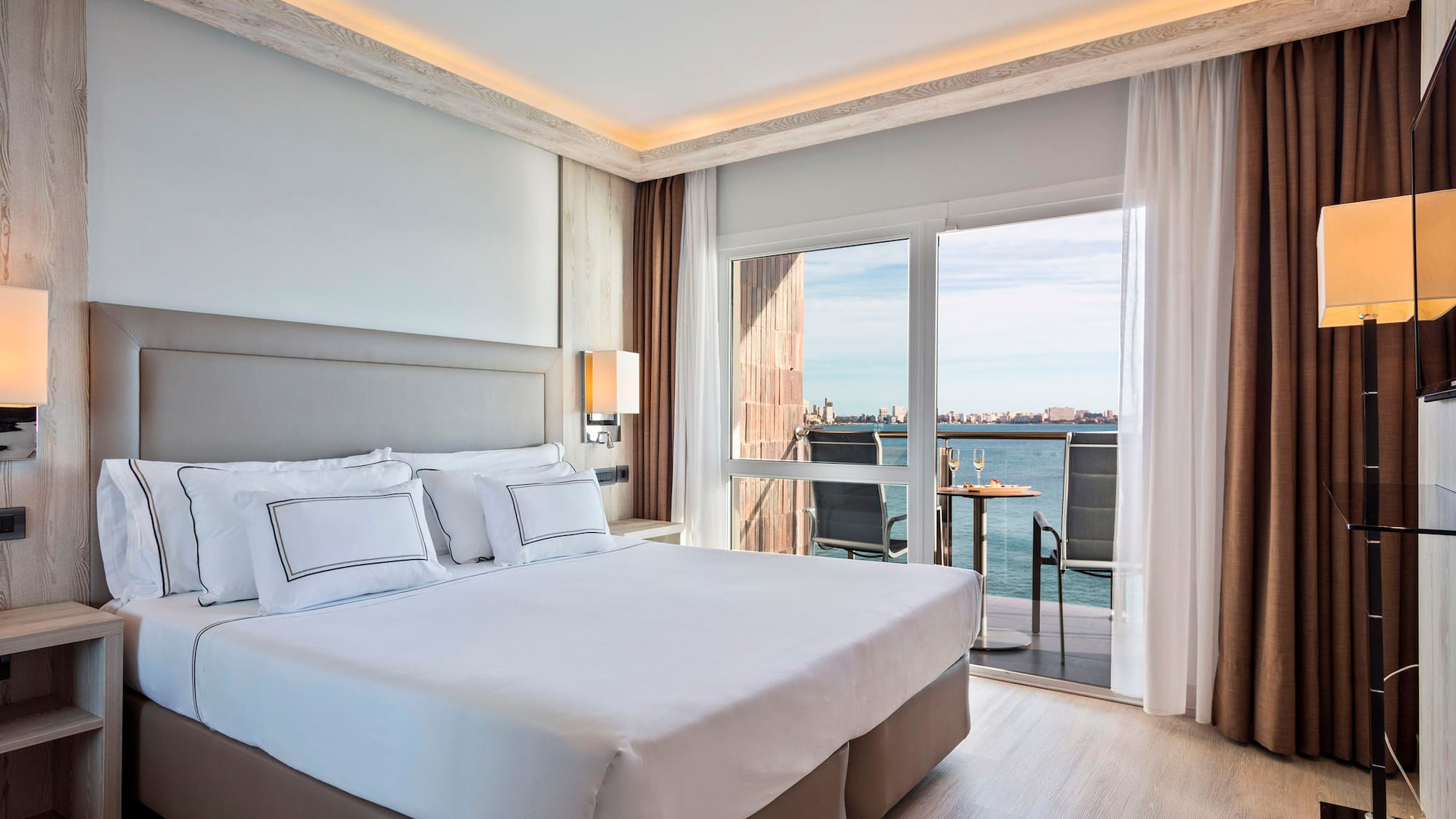 a bed with a view of the ocean