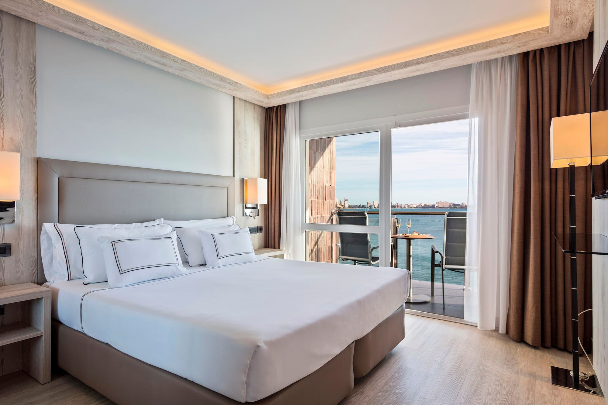 a bed with a view of the ocean