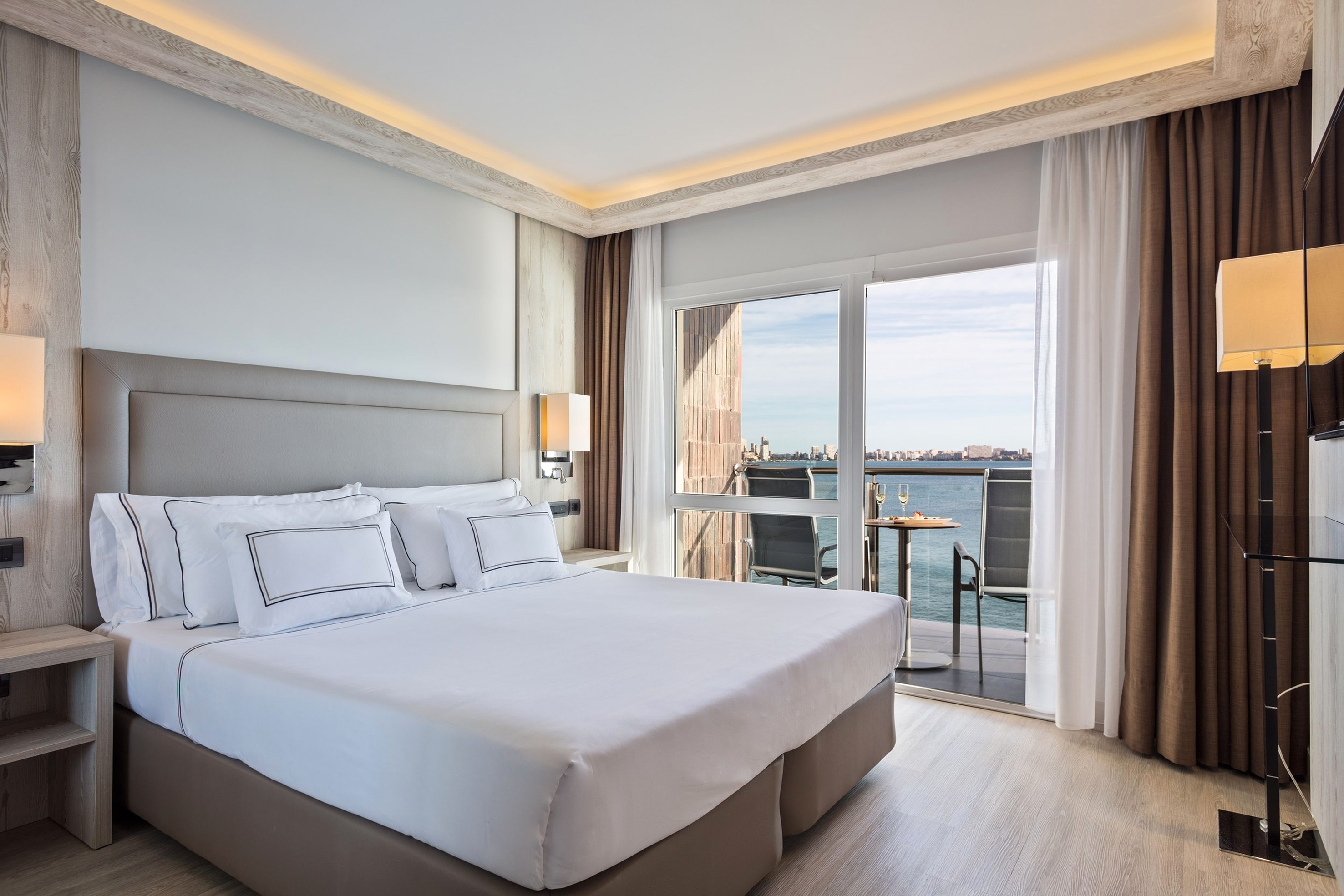a bed with a view of the ocean