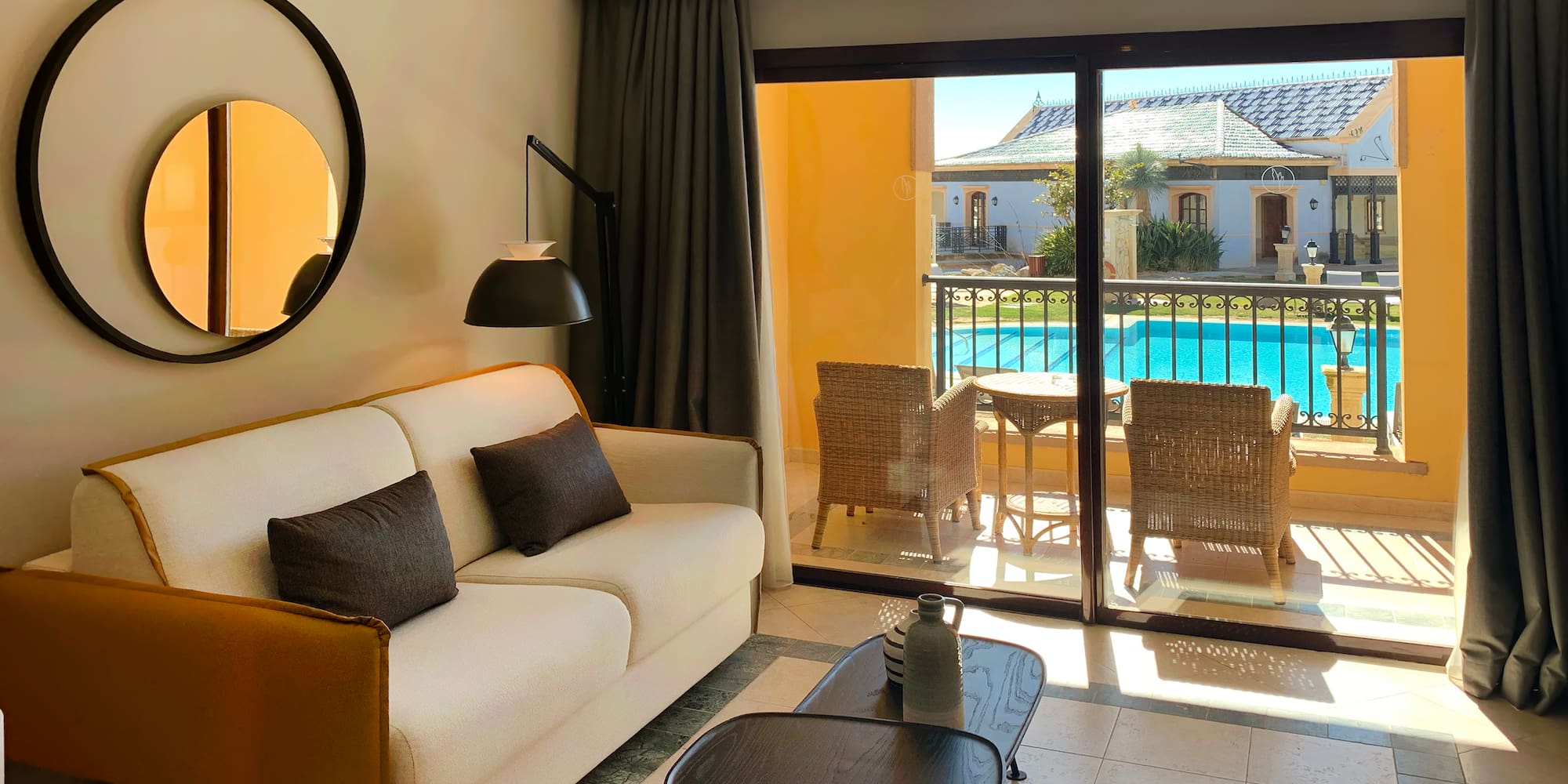 a living room with a glass door and a couch