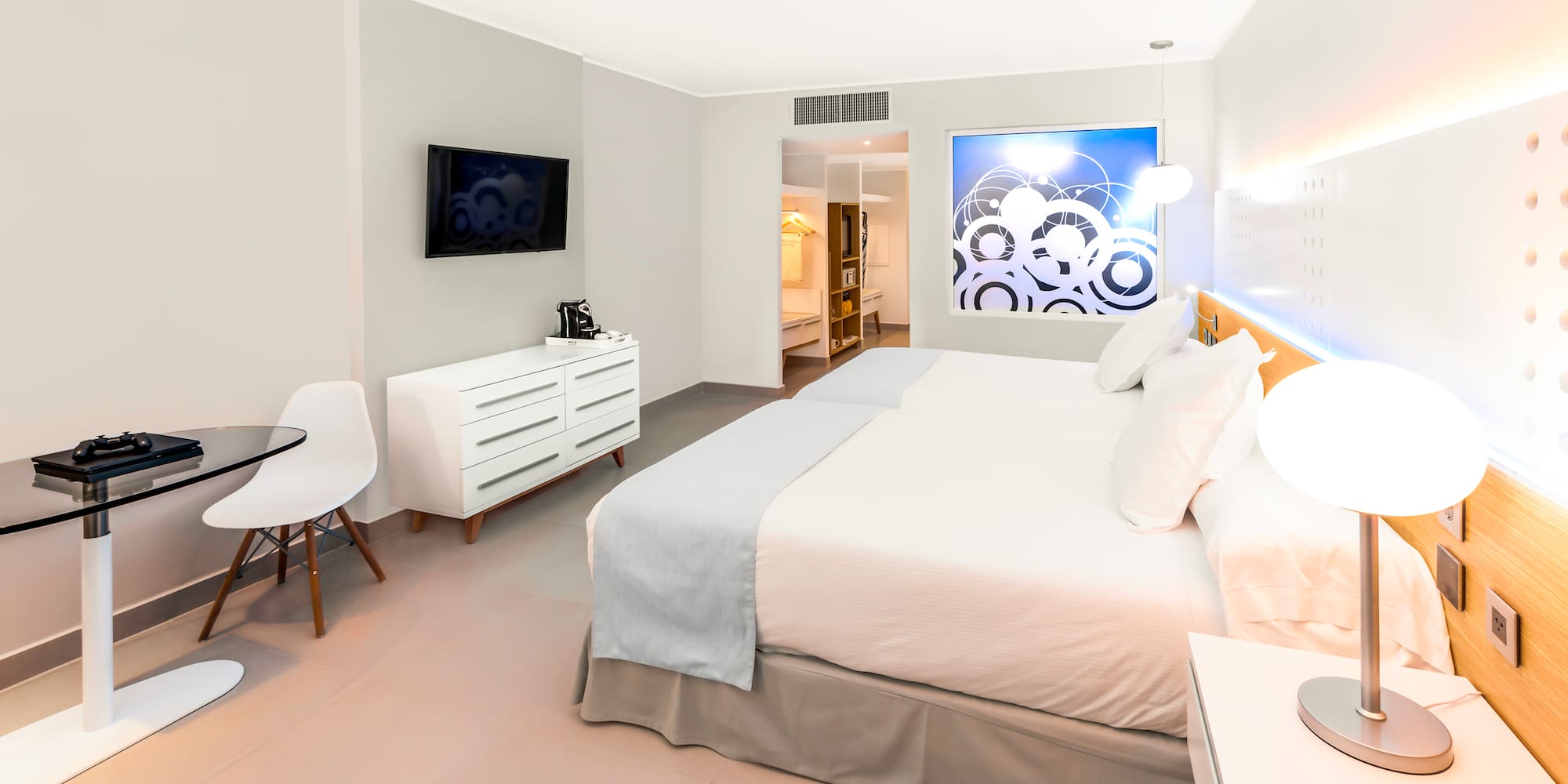 a bedroom with a bed and a tv