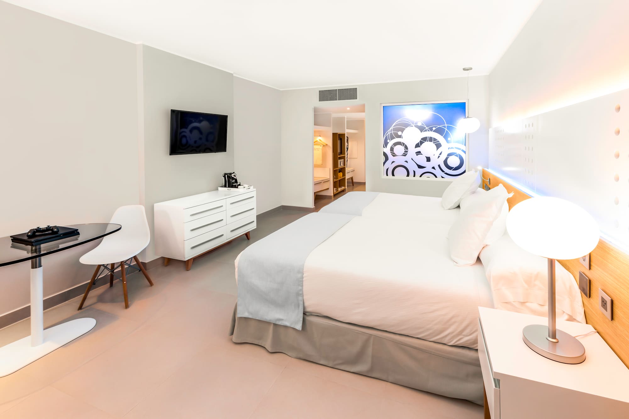 a bedroom with a bed and a tv