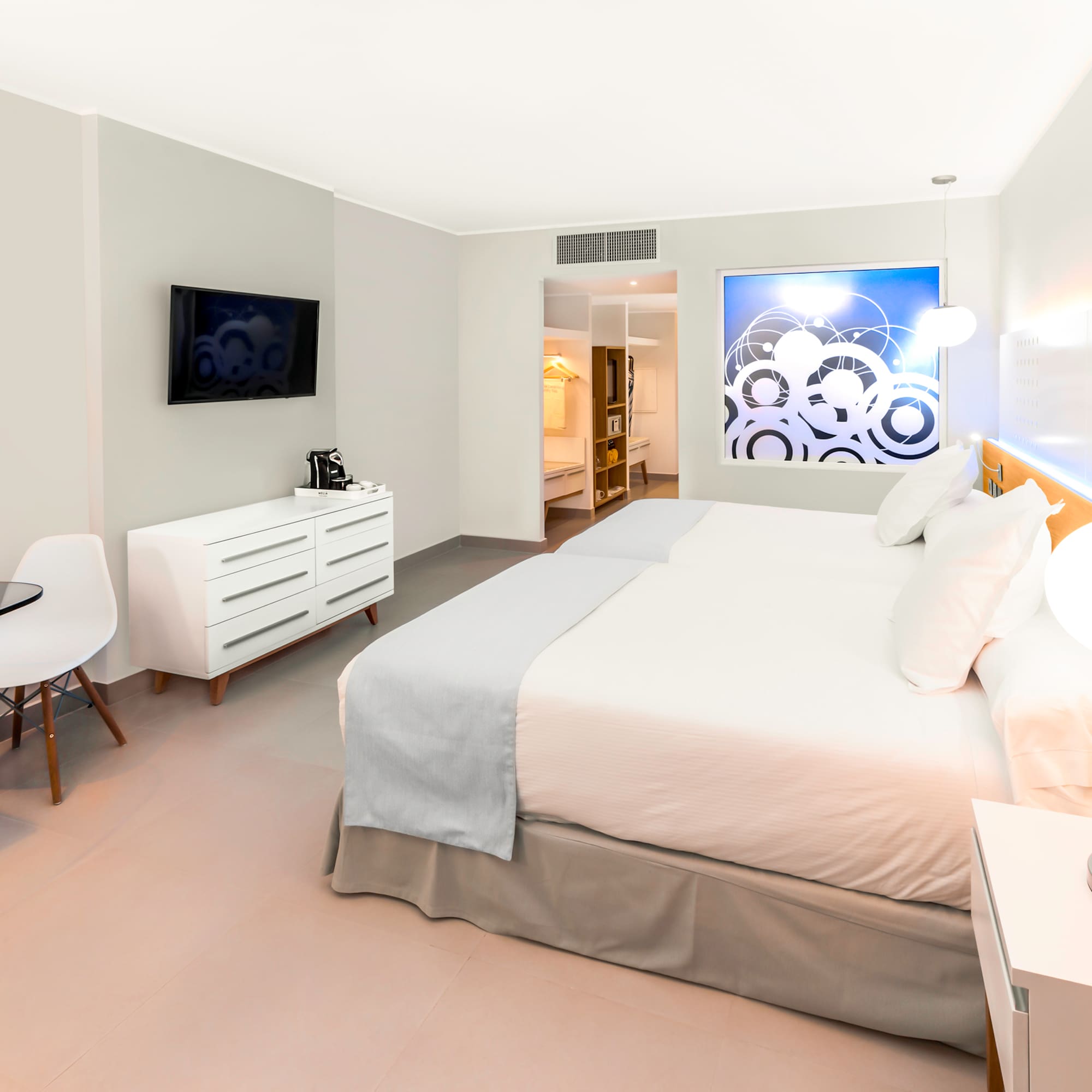 a bedroom with a bed and a tv