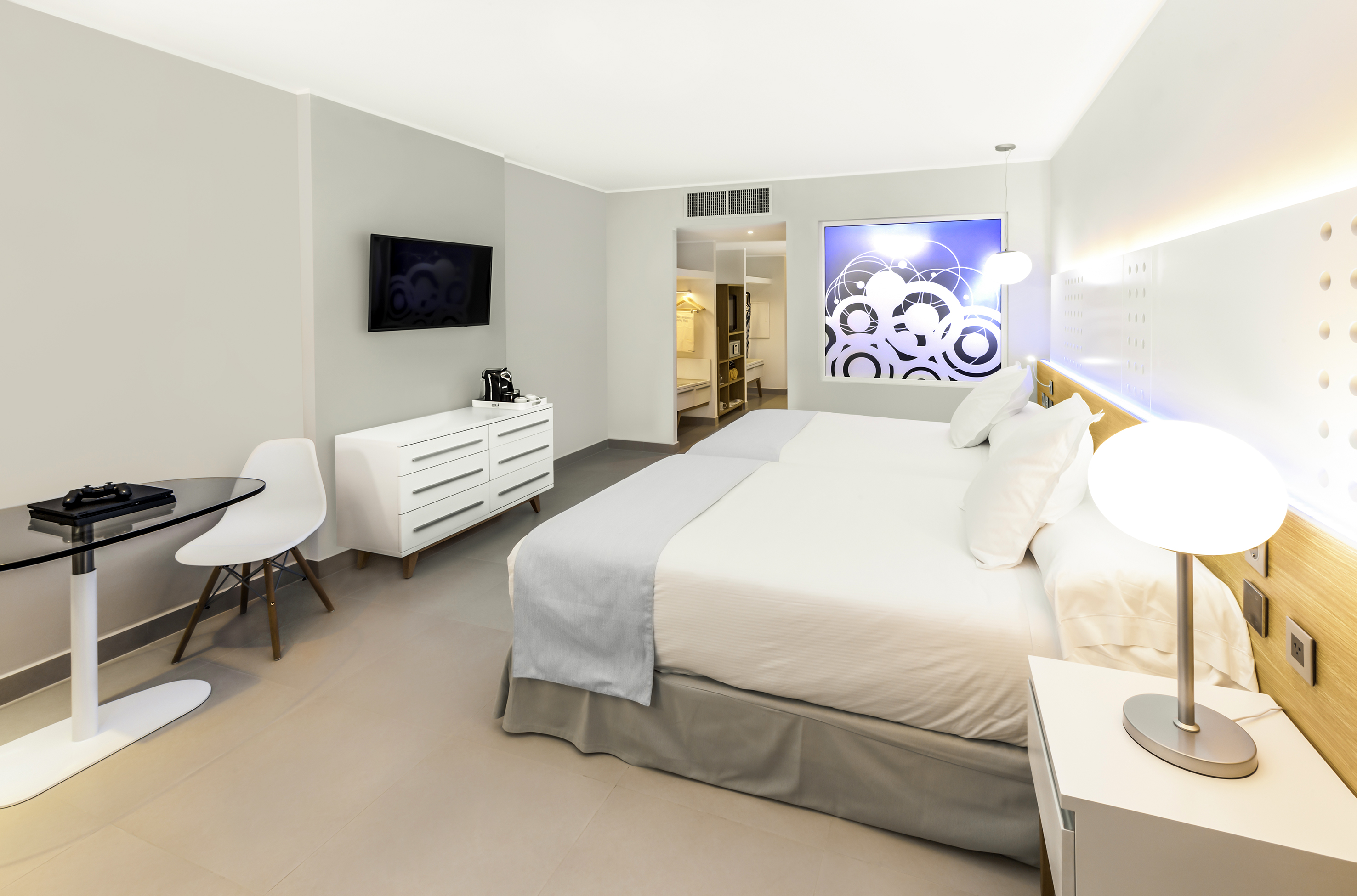 a bedroom with a bed and a tv