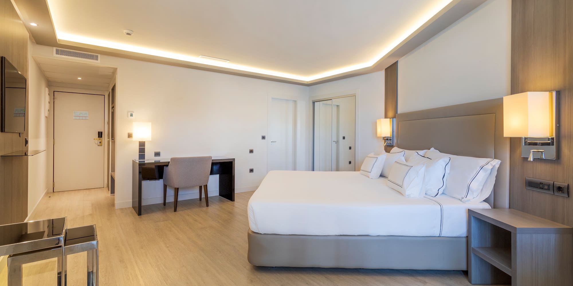 a room with a bed and a desk