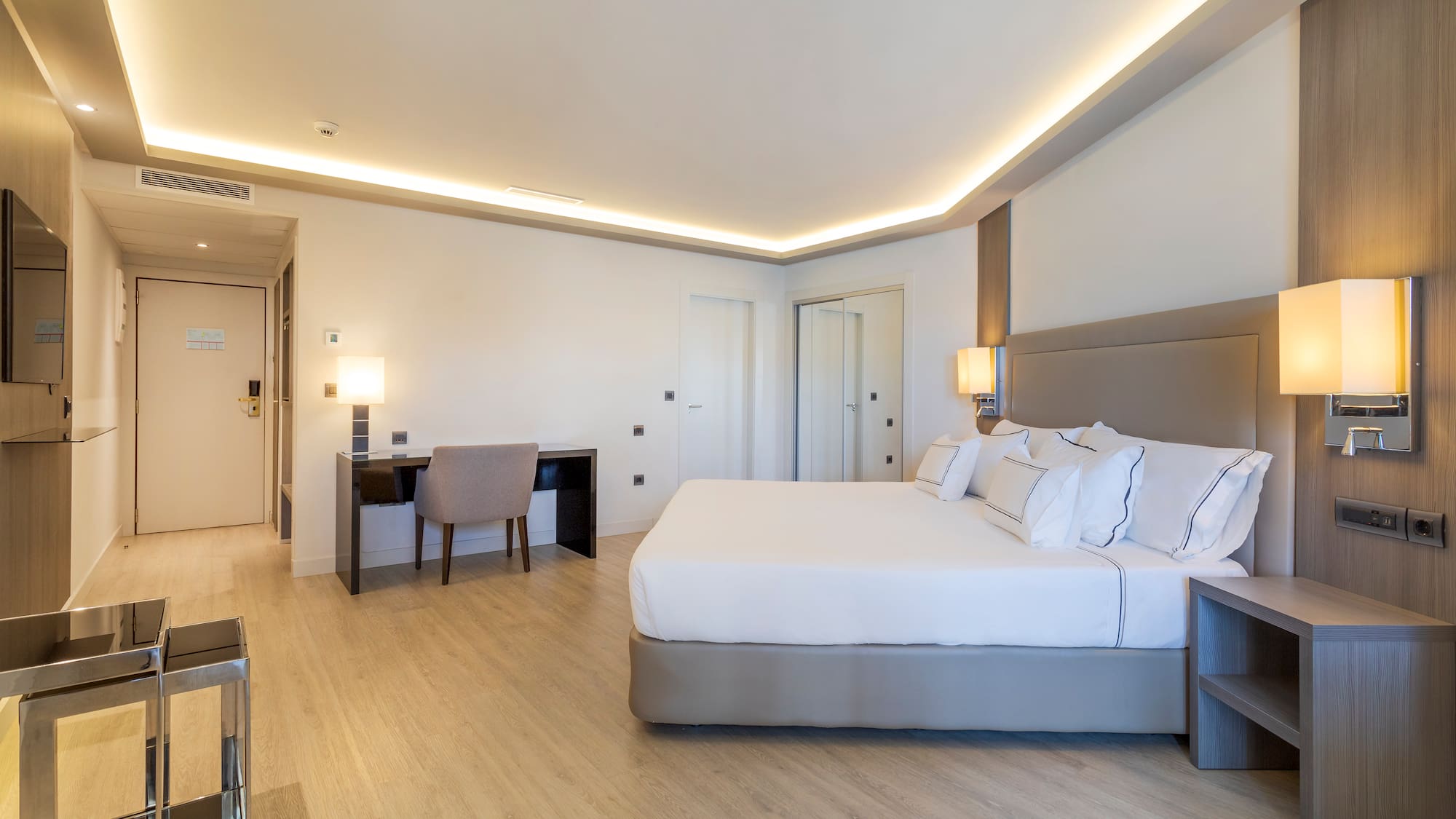 a room with a bed and a desk