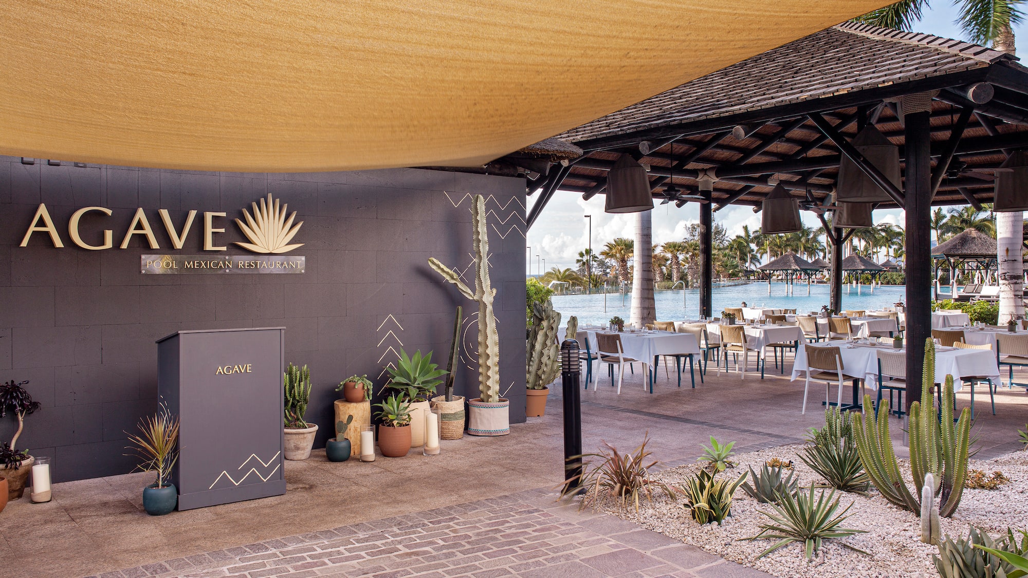a patio with a large awning and tables and chairs