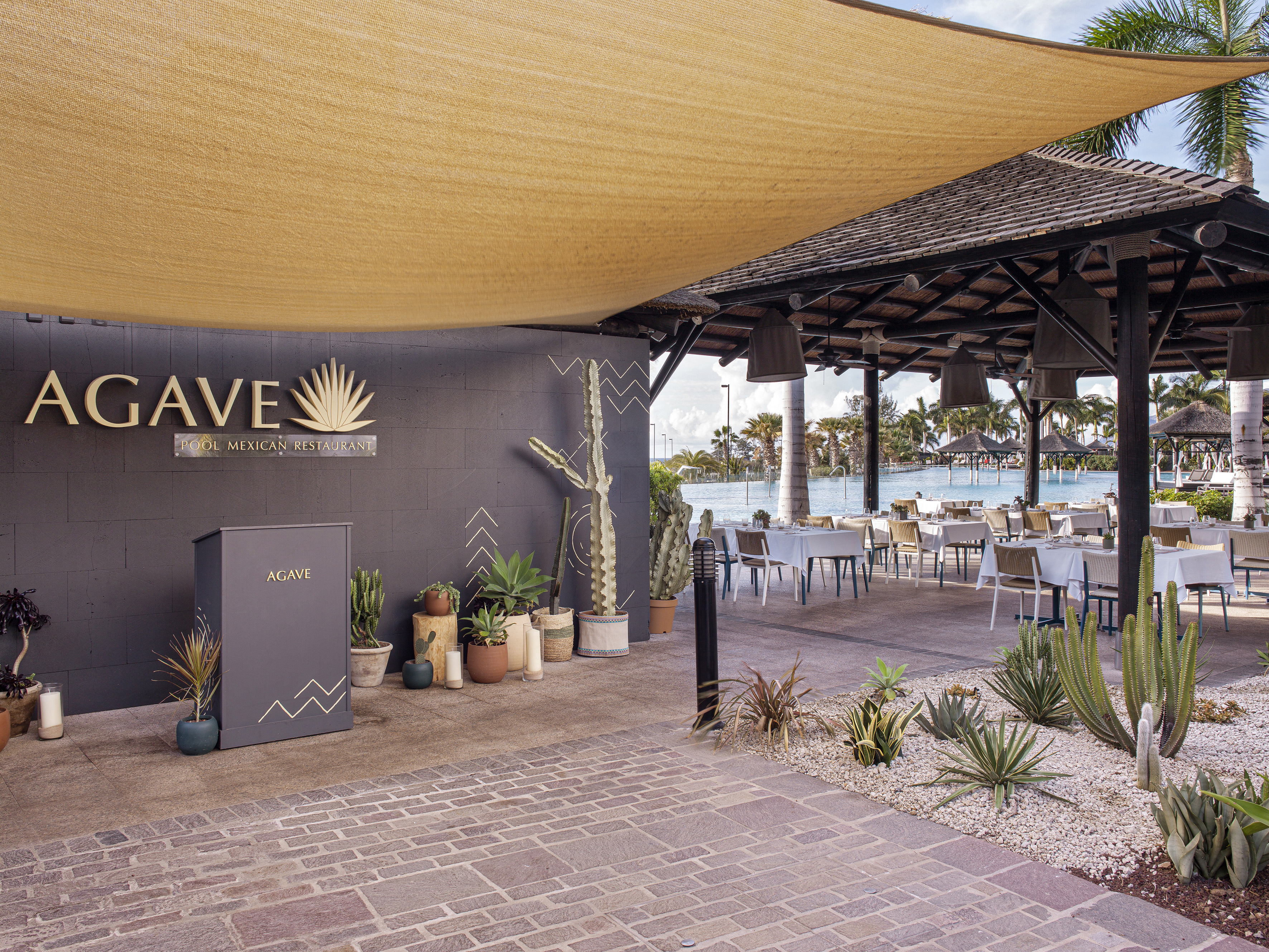 a patio with a large awning and tables and chairs