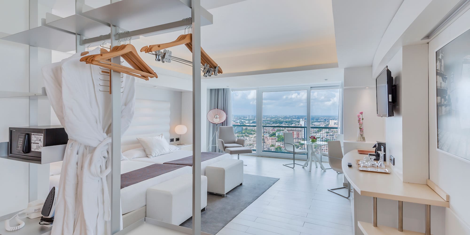 a room with a bed and a television