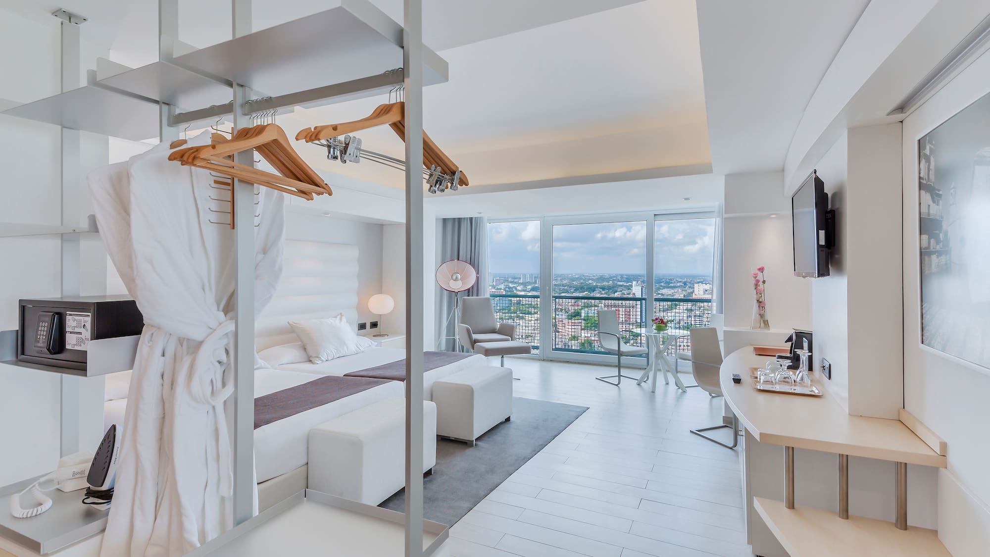 a room with a bed and a television