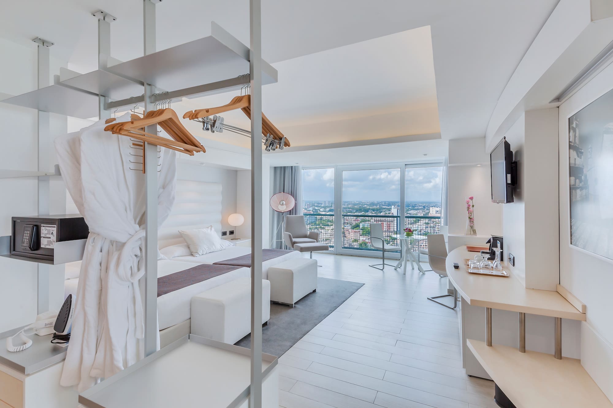 a room with a bed and a television