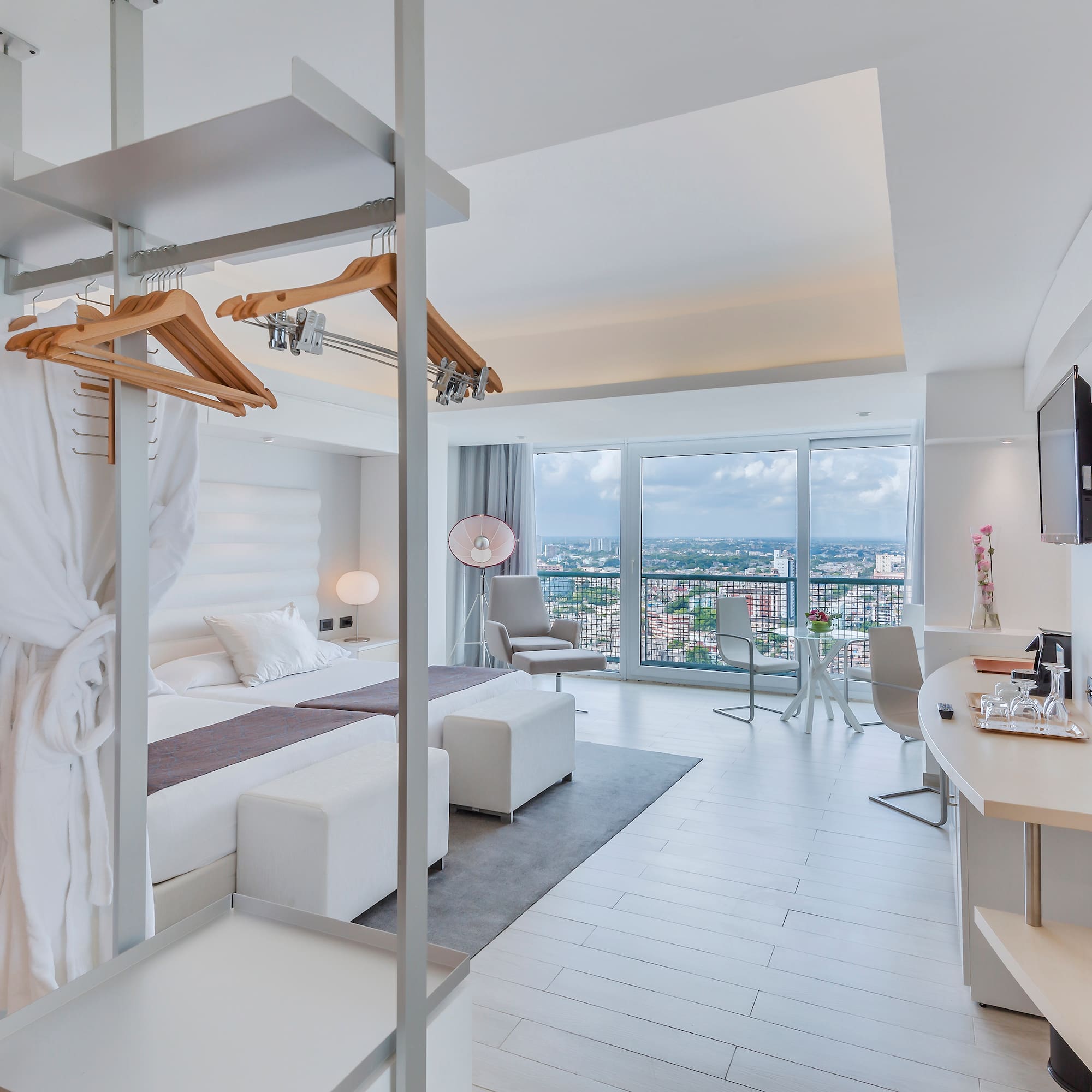 a room with a bed and a television