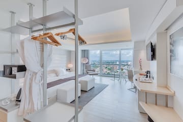 a room with a bed and a television
