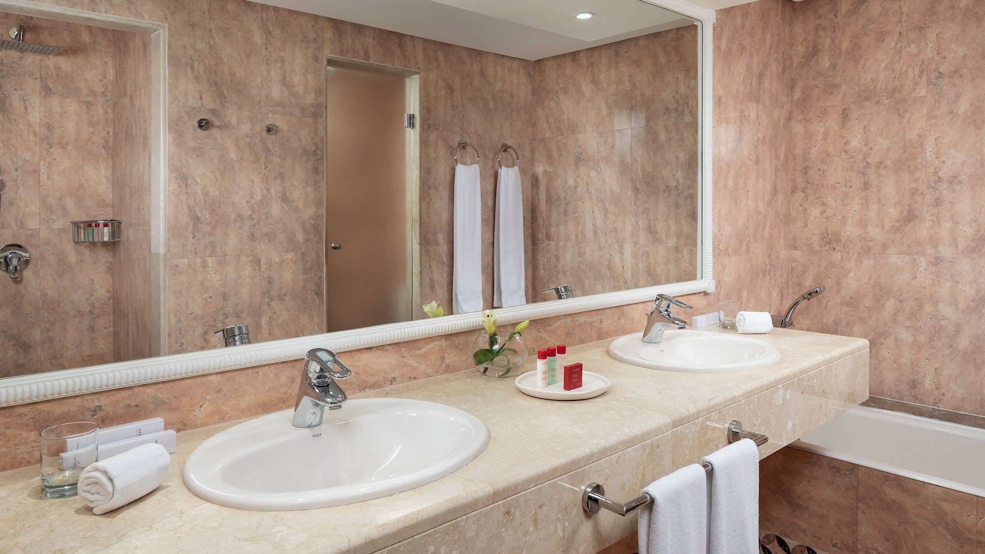 a bathroom with double sinks and a mirror