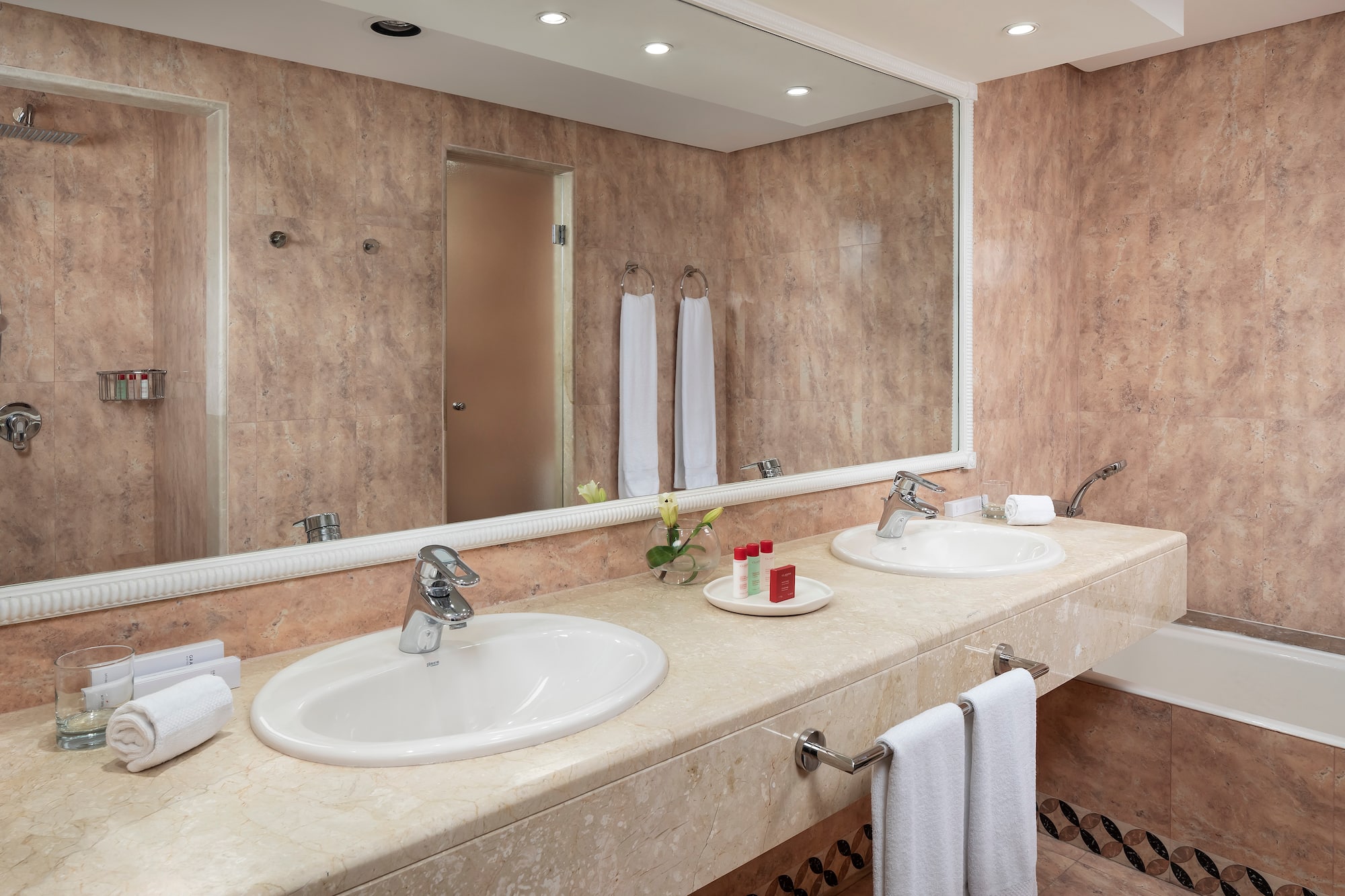 a bathroom with double sinks and a mirror
