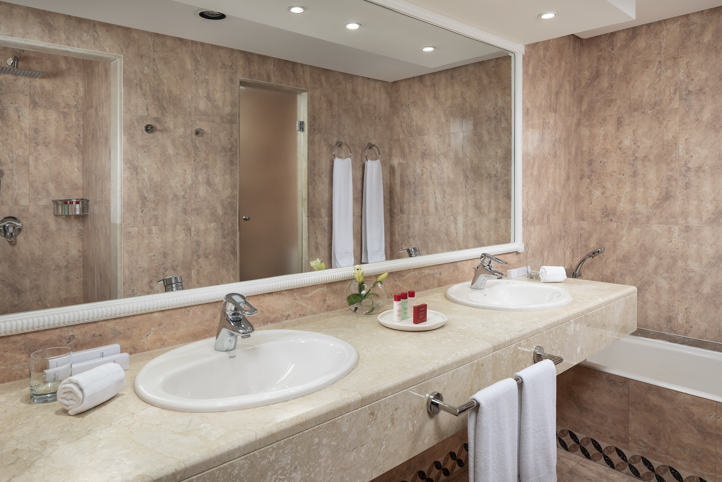 a bathroom with double sinks and a mirror