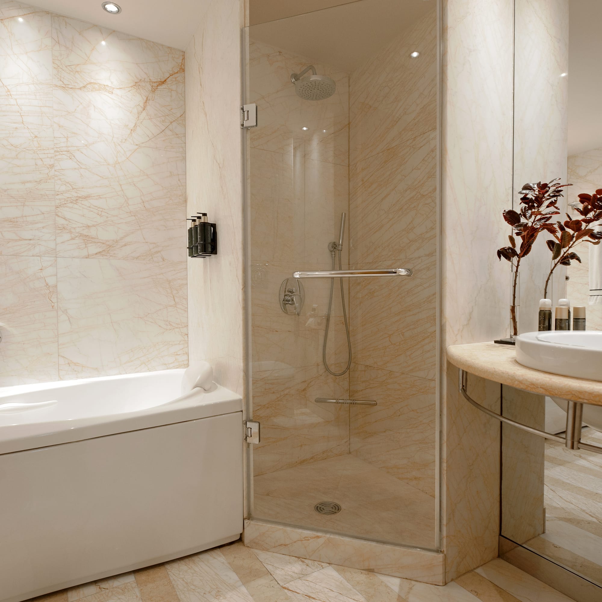 a bathroom with a glass shower and tub