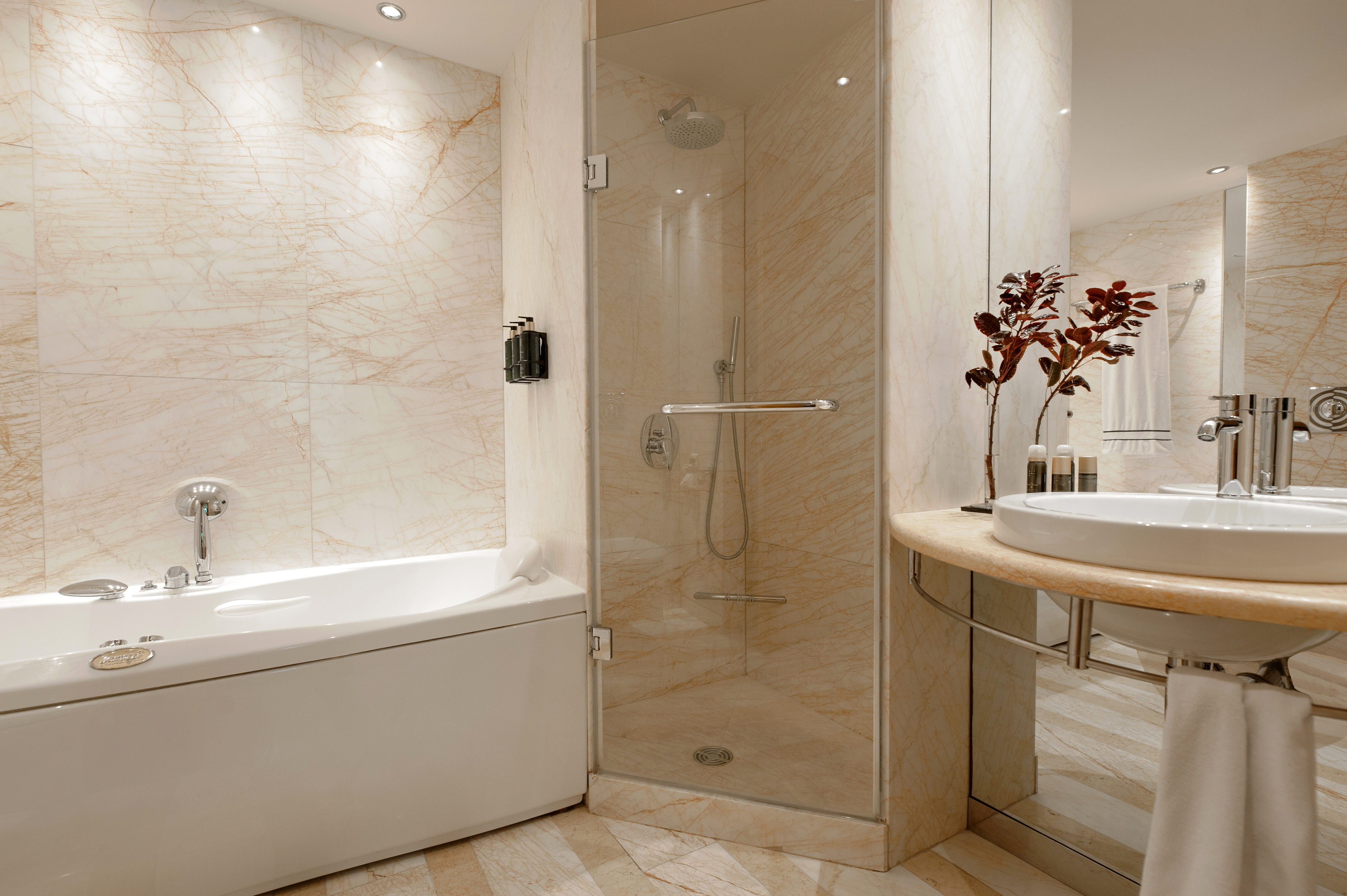 a bathroom with a glass shower and tub