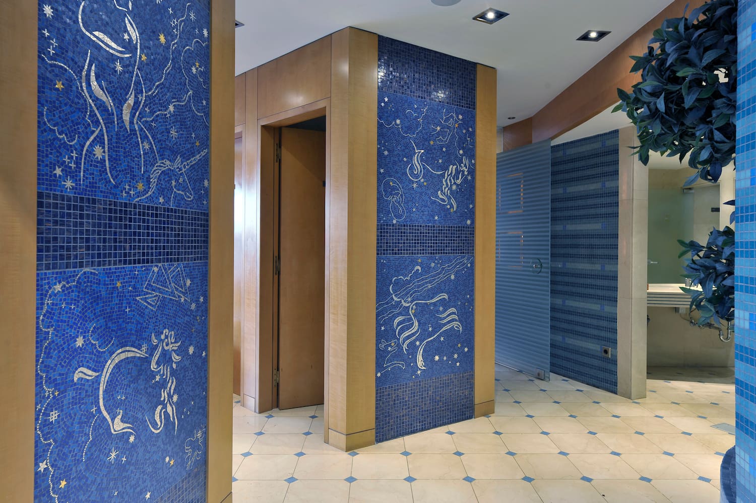 a blue tile wall with a white tile floor