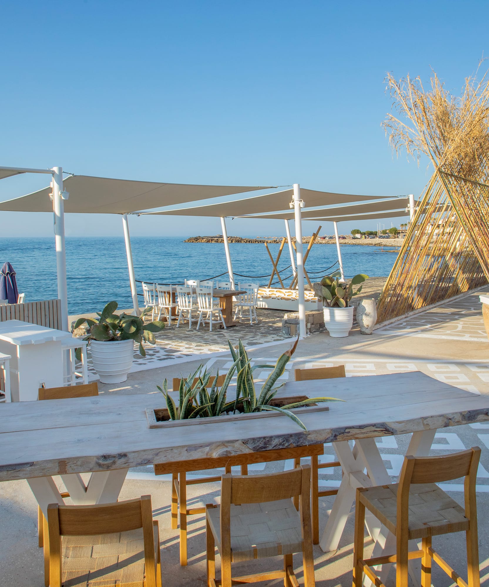 a table and chairs on a beach